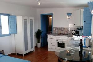 a kitchen with a table with wine glasses on it at The Vine Studio in Rubite
