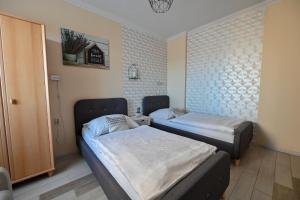 Posteľ alebo postele v izbe v ubytovaní BellaVista 1 Apartman