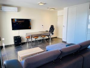 a living room with a couch and a table at T2 récent 45m2, Parking inclus, Clim in Aix-en-Provence