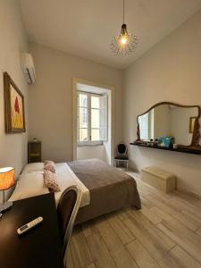 a bedroom with a large bed and a mirror at Cupola San Marcellino in Naples +25 photos
