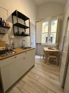 a kitchen with a sink and a table at Cupola San Marcellino in Naples