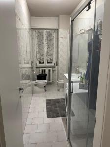 a bathroom with a shower and a toilet and a sink at CINI Infinity HOUSE in Cinisello Balsamo