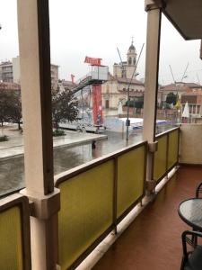 a balcony with a view of a city in the rain at CINI Infinity HOUSE in Cinisello Balsamo