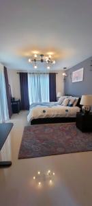 a large bedroom with two beds and a rug at Bloomfields Residences in Balintiouac