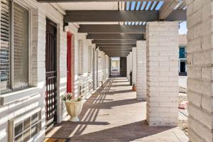 an empty hallway of a building with a vase at Days inn by Wyndham Albuquerque Northeast in Albuquerque