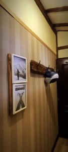a wall with two pictures and a pair of shoes at Uki & Sofi mountain house in Kopaonik