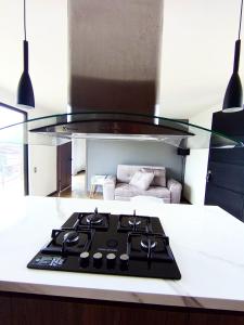 a kitchen counter with a stove top in a room at Hermosa Villa con piscina in Los Santos