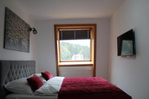 a bedroom with a bed and a window at Ski Mont Apartment Jahorina in Jahorina