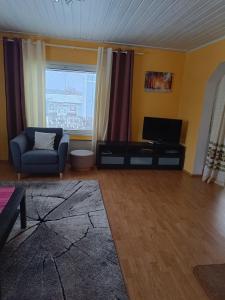 sala de estar con sofá y TV en Aurinko, en Varkaus