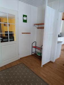 an empty room with a door and a shelf at Aurinko in Varkaus