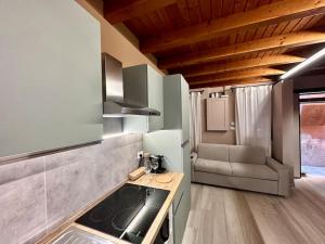 a kitchen with a stove and a couch in a room at Incantevole Casetta Veneziana in Venice +20 photos