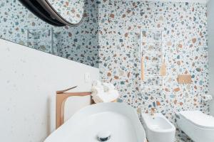 a bathroom with a toilet and a sink at Albergo Dipinto BaccoFurore in Furore