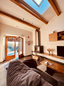 a large living room with a skylight at Mas Vermell in Fontanilles