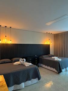 Ένα ή περισσότερα κρεβάτια σε δωμάτιο στο Villa'S Roraima - Pousada & Natureza