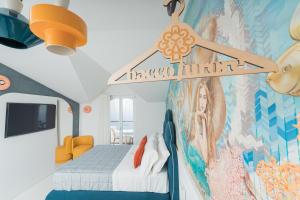 a room with a bed and a painting on the wall at Albergo Dipinto BaccoFurore in Furore