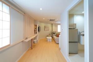 a hallway with a kitchen and a living room at Senlax Inn Osaka in Osaka