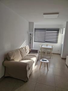 a living room with a couch and a table at La Casita de la Charca in Melenara