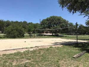 a person is playing a game of volleyball at Enchanting Texas Home Pool Gameroom Firepit in San Antonio