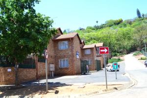 a brick building with a street sign in front of it at Soldout Camp 2 in Pretoria