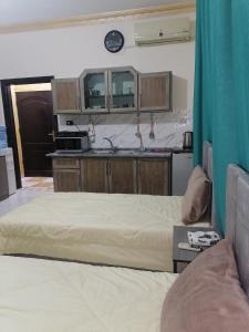 a room with two beds and a kitchen at Yaso Roof & Apartments in Amman