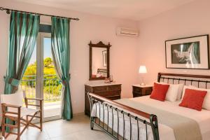 a bedroom with a bed and a balcony at Villa Aquamarine in Kounopetra