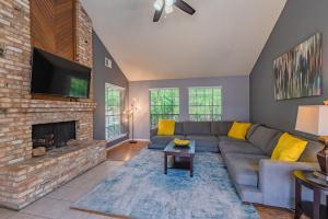 a living room with a couch and a fireplace at Fun 'n Sun Heated Pool & Gameroom By Fiesta Texas in San Antonio