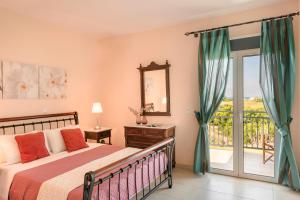 a bedroom with a bed and a balcony at Villa Sapphire in Kounopetra