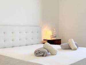 a white bed with two pillows on top of it at Suites Montemare in San Vito Chietino