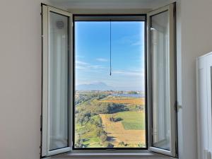 an open window with a view of a field at Suites Montemare in San Vito Chietino