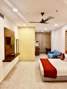 a bedroom with a bed and a living room at Amora Rooms Dwarka in New Delhi