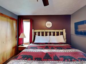 a bedroom with a bed with a patterned blanket at Our Happy Place in McHenry