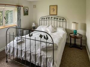 a bedroom with a bed with a wrought iron bed frame at Edgecoombe in Shaftesbury