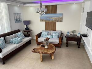 a living room with a couch and a table at Villa hermosa en Playa Nueva Romana in San Pedro de Macorís