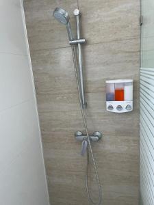 a shower with a shower head in a bathroom at Villa hermosa en Playa Nueva Romana in San Pedro de Macorís