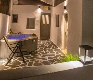 a bathroom with a tub and a counter with a floor at La Vista Santorini in Fira