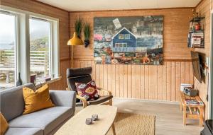 a living room with a couch and a table at Gorgeous Home In Straumsjen With House A Panoramic View in Straumsjøen