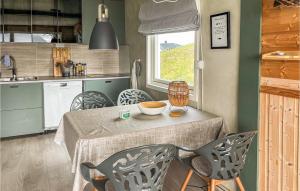 a kitchen with a table and chairs in a kitchen at Gorgeous Home In Straumsjen With House A Panoramic View in Straumsjøen