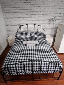 a bed with a black and white checkered blanket at Spacious room private balcony - Central London - zone 1 - Elephant and Castle in London