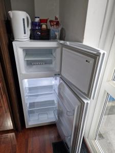 an empty refrigerator with its door open in a kitchen at Spacious room private balcony - Central London - zone 1 - Elephant and Castle in London