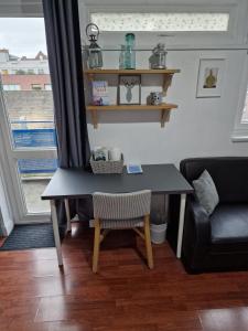 a table in a living room with a couch at Spacious room private balcony - Central London - zone 1 - Elephant and Castle in London
