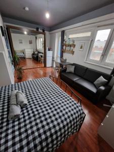a living room with a bed and a couch at Spacious room private balcony - Central London - zone 1 - Elephant and Castle in London