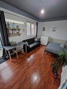 a living room with a couch and a table at Spacious room private balcony - Central London - zone 1 - Elephant and Castle in London