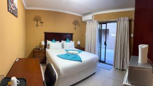 a bedroom with a bed and a desk and a window at The bridge Guest House in Newcastle