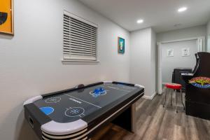 a room with a ping pong table in the corner at Luxurious Home With Hot Tub & Tree Deck By 6flags in San Antonio