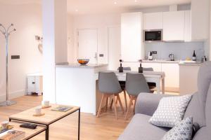 a kitchen and living room with a couch and a table at Zenete Terral Málaga in Málaga