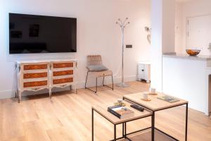 a living room with a dresser with a flat screen tv at Zenete Terral Málaga in Málaga