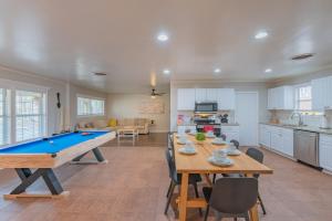 a living room with a pool table and a kitchen at Texas Vacation Home, Game Room & Pool By Sixflags in San Antonio