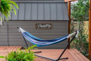 a hammock on a deck in front of a garage at Jetted Pool & Firepit In Stunning Home By Airport in San Antonio