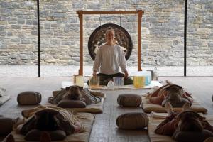a group of people sitting in aorative yoga class at Bell Flat in Broughton Hall in Skipton