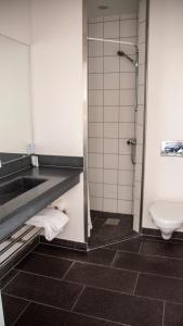 a bathroom with a sink and a toilet at Hotel Strandtangen in Skive +81 photos